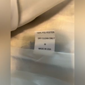 Medium size, short waist length jacket, pretty blue print and large buttons.